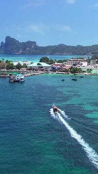 Longtail boat sailing to Phi phi island, Thailand. Vertical.