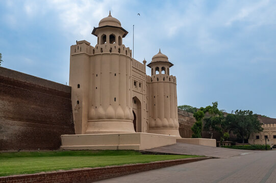 Visit to Badshahi Mosque in Lahore, Pakistan, showcasing its architecture and gardens near the entrance during the day