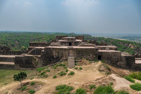 Ruins of Rohtas Fort reveal ancient architecture in Punjab, Pakistan amid green landscape and blue sky