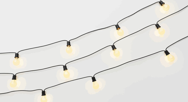 String lights with glowing bulbs black cable on a light gray background