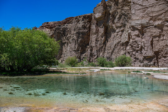Exploring the multi coloured lake at Band-e-Amir National Park in Afghanistan surrounded by rocky cliffs and greenery