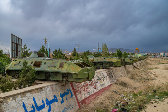 Russian tanks positioned along a river bed in Afghanistan show remnants of conflict and military presence in the area