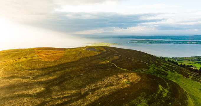Aerial view of Queen Maeve Cairn on Knocknarea above the coast in County Sligo, Ireland. A prehistoric summit monument set in a dramatic Irish landscape.