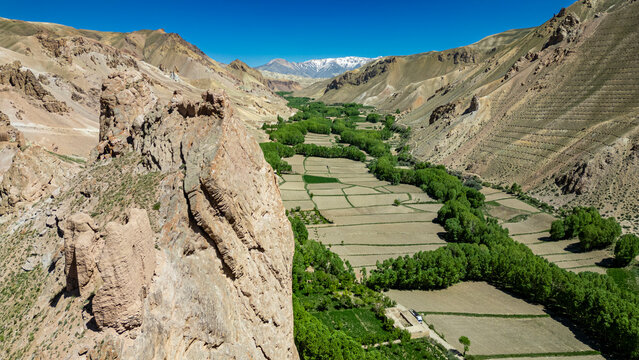 View of castle Gorgaheen overlooking the valley in Bamiyan province with fields and mountains in the background