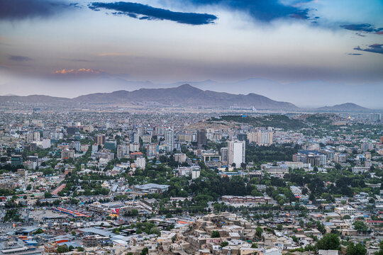 Scenic overlook shows the city of Kabul and surrounding mountains at dusk