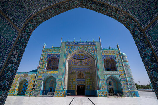 Visit to the Mausoleum of Imam Ali with its blue tiles and distinct architecture in Mazar-e-Sharif, Afghanistan under clear skies