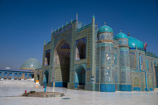 Blue mosque stands tall in Mazar-e-Sharif with intricate tile work and clear sky above