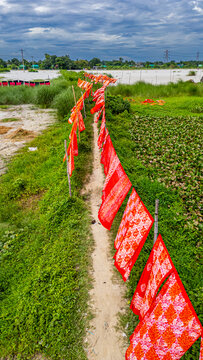 Cloths drying on a path in rural Bangladesh under cloudy skies in the village of Araihazar