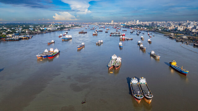 View of anchoring boats on Karnaphuli River near fish market in Chittagong Bangladesh during daylight hours