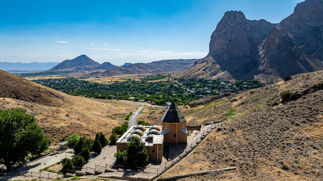 Overhead view of Sheikh Khorasan mausoleum surrounded by mountains in Nakhchivan, Azerbaijan with valley below