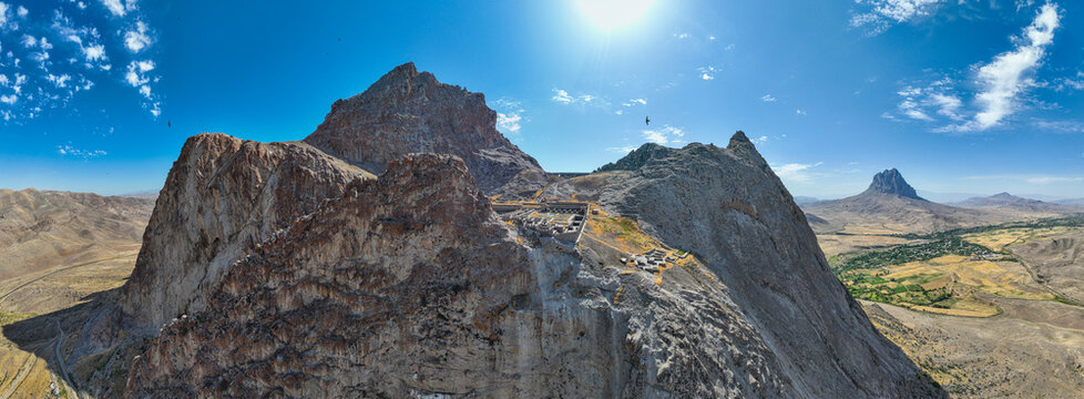 View of Alinja castle perched on a mountain in Nakhchivan, Azerbaijan with vast landscape in the background
