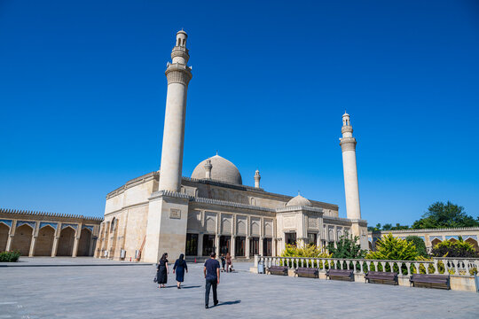 Visitors walk near the Jummah Mosque in Shamakhi while enjoying clear skies in Azerbaijan