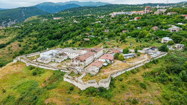 Aerial view of a former prison site surrounded by greenery in Qarabaqh region of Azerbaijan showcasing remnants of past structures