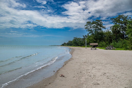 Visitors enjoy Casuarina beach on a sunny day in Jaffna district, Sri Lanka, with clear skies and gentle waves