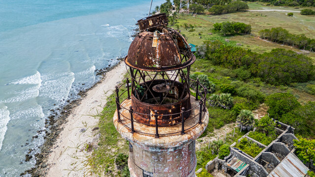 Kovalim lighthouse stands tall on the shoreline with waves crashing nearby in Jaffna district Sri Lanka