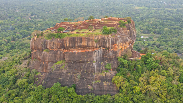 View of Sigiriya rock fortress surrounded by lush greenery in Central Province, Sri Lanka during daytime
