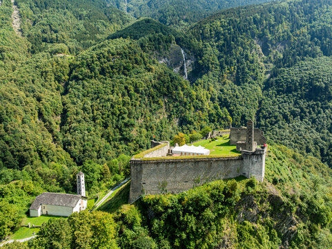 Mesocco castle sits atop a hill surrounded by trees in Tessino, Switzerland promoting cultural heritage and history