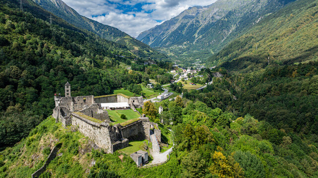 Mesocco castle shows its structure and surroundings under the sky with clouds in Tessino, Switzerland