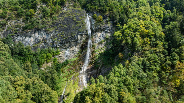 View of Mesocco castle from above surrounded by lush green trees in the landscape of Switzerland