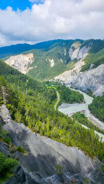 Aerial view of the winding Rhein gorge in Switzerland showing cliffs and greenery along the river's path
