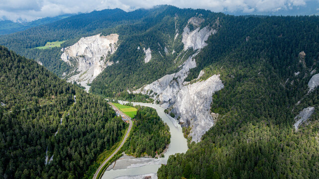 Rhein gorge shows winding river and steep cliffs with green forest in Switzerland