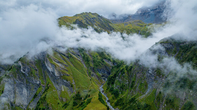 Aerial view of Tschinglengorge in Sardona National Park showing rocky slopes and cloud cover in Switzerland