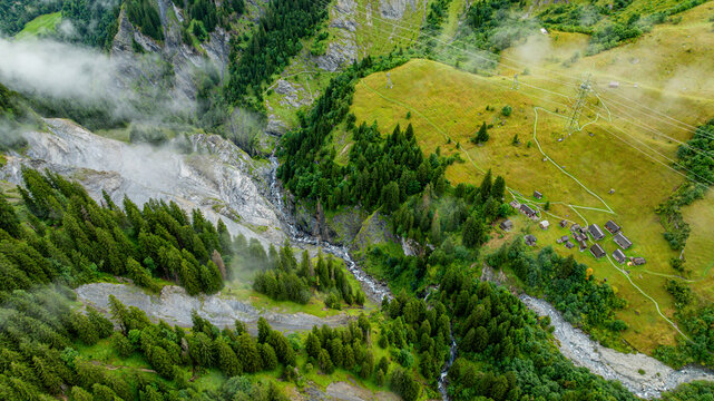 Aerial view of the Tschinglengorge in Sardona National Park capturing steep cliffs and green fields in Switzerland