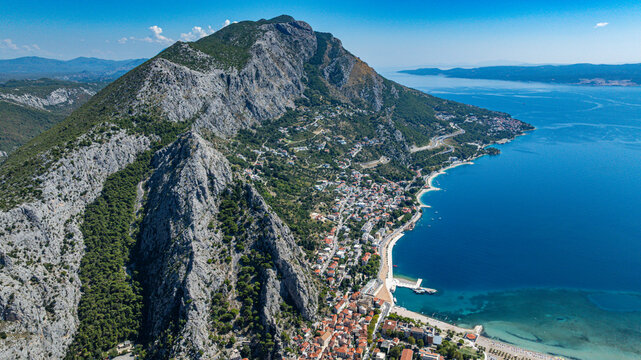 Omis coast features rocky mountains and clear water in Croatia near the town and beach