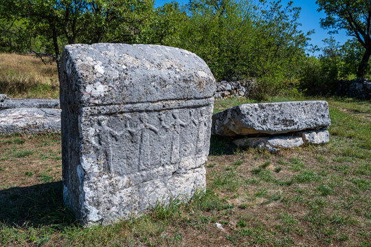 Stecci medieval tombstones in a historic graveyard showcase ancient craftsmanship in Croatia's landscape