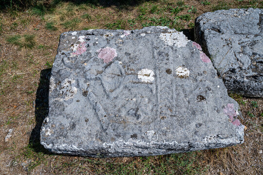 Historical stone with carvings located at the Stecci Medieval Tombstone Graveyards in Croatia displaying ancient art