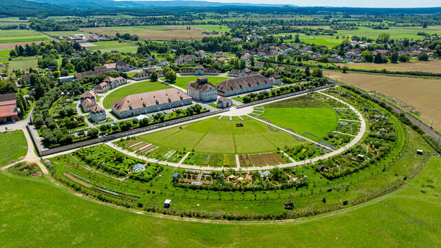 Aerial view of the Royal Saltworks showcasing gardens and buildings in a green landscape of France