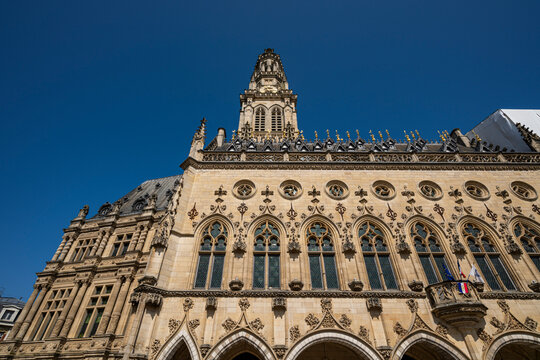Belfries of Arras stand tall under a clear sky showcasing their architectural beauty and history in France