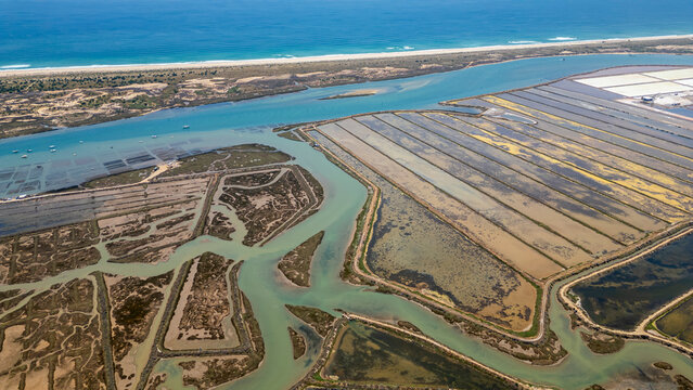 View of saltpans and waterways near the coast in Algarve, Portugal during daylight hours