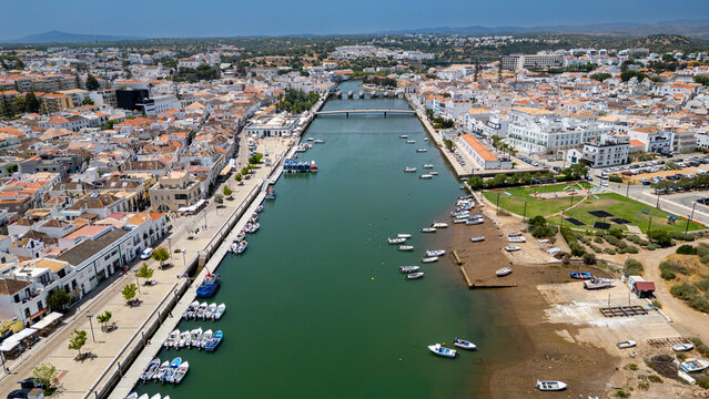 Historic city of Tavira reveals boats along the river and architecture among white buildings in Portugal