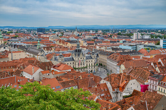 View from Schlossberg showing historic rooftops of Graz and surrounding areas in clear weather conditions over the Unesco site