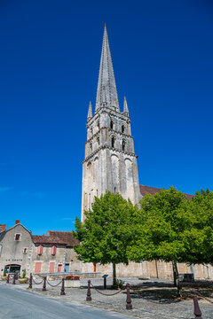 Exploring the architecture of the Abbey Church of Saint-Savin-sur-Gartempe in France under a clear blue sky