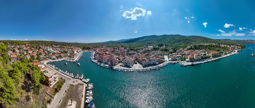 View of the old town of Stari Grad on Hvar island with boats in the harbor and hills in the background