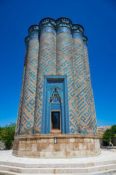 Mausoleum with intricate tile work in Garabaghlar, showcasing Azerbaijani architecture in a clear blue sky