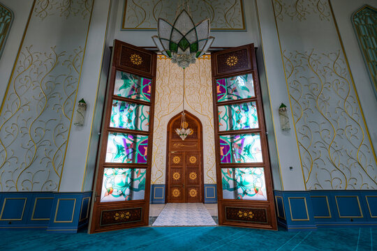 Interior view of Haydar Mosque showing stained glass doors and ornate design elements in Nakhchivan Azerbaijan