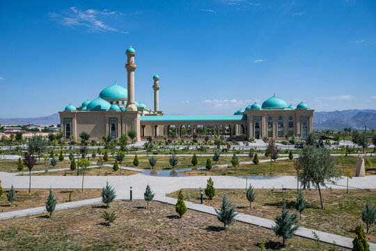Explore Haydar Mosque in Nakhchivan and its large garden in Azerbaijan with clear skies and mountains in the background