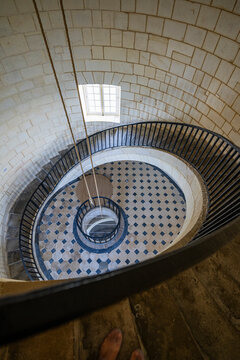 Stairwell view inside the lighthouse of Cordouan in France with spiral design and visible stones
