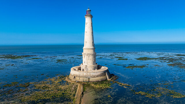Aerial view of Cordouan lighthouse surrounded by calm waters and rocks in France