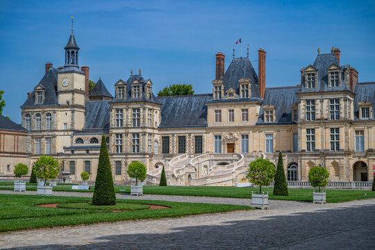 Fontainebleau palace showcases architecture and gardens under clear sky in France