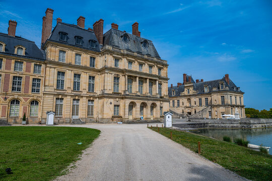 Exploring the architecture and gardens of Fontainebleau palace in France on a clear day