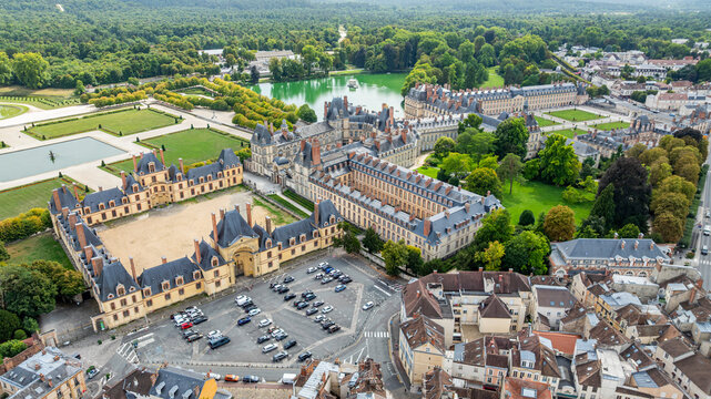 Explore the aerial view of Fontainebleau palace and gardens in France showing the historic architecture and lush landscape