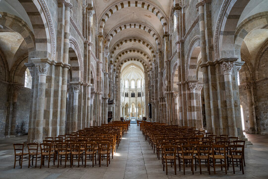 Vezelay Abbey showcases its interior architecture and seating arrangement for visitors in France