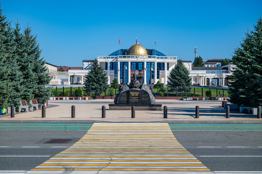 Headquarters of the Republic of Ingushetia located in Magas with a statue in front during clear weather