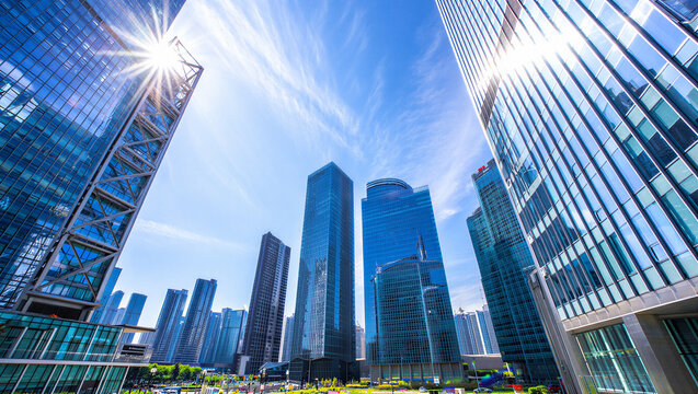 Low angle perspective of modern glass skyscrapers and skyscrapers in a sunny city business district