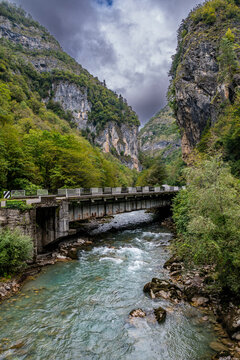 Lupshara river flows under the bridge in Ritsa Relict National Park, showcasing natural beauty in Abkhazia, Russia