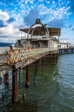 Old casino structure on a pier along the Ocean promenade in Sukhumi, Abkhazia overlooking the water and sky